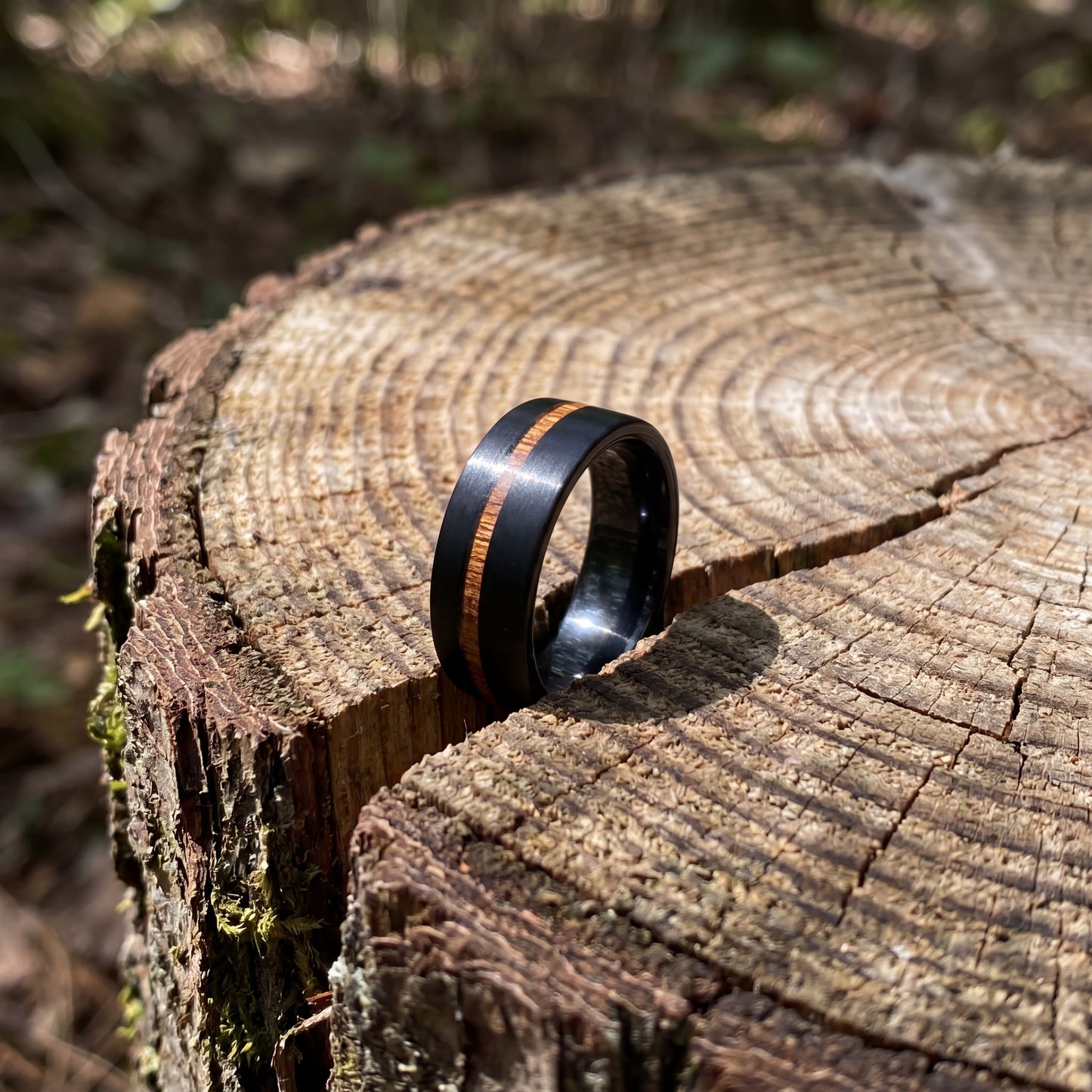 Black tungsten ring with cherry wood inlay